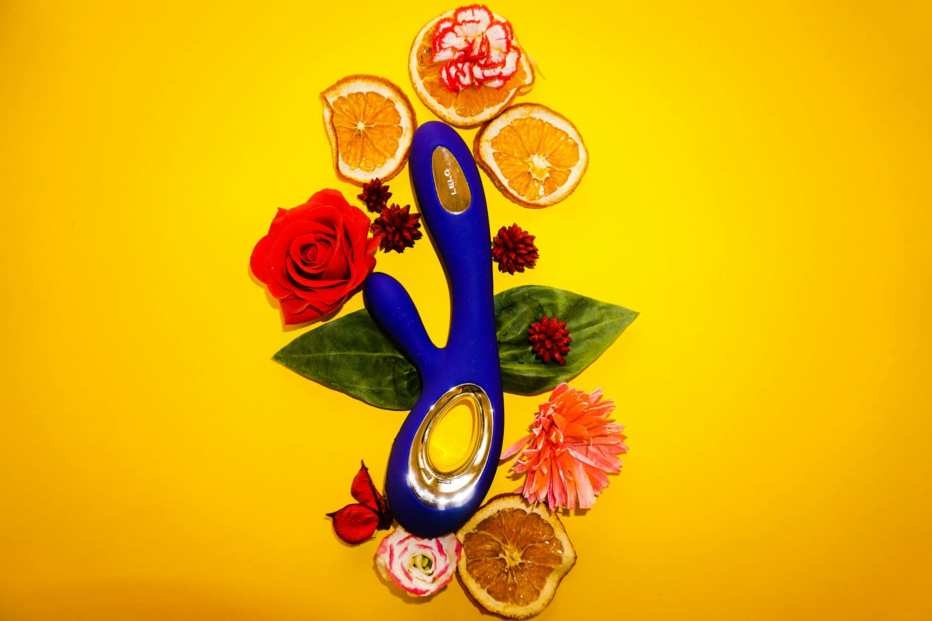 Yellow silicone vibrator surrounded by peeled bananas on a bright yellow background, representing sensitivity and natural body changes
